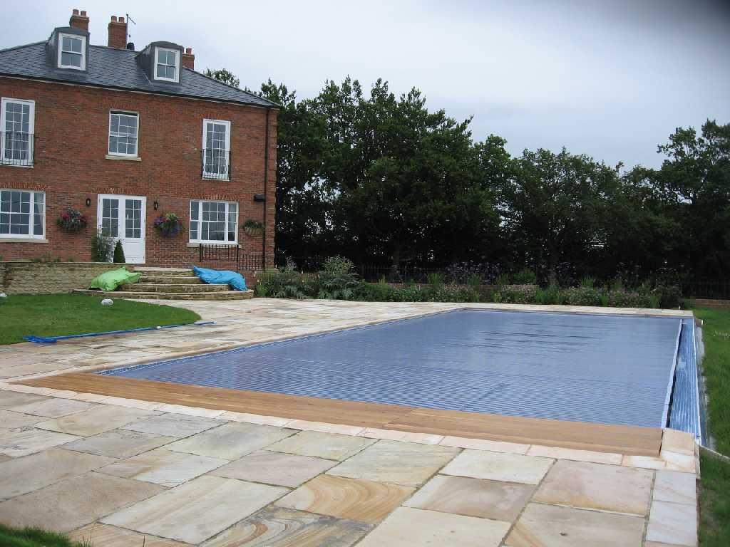 Wooden deck lid over a pool